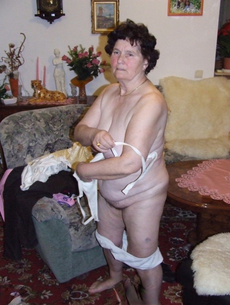 Mature fatty Hildegard strips and shows her huge tits and ass in a solo