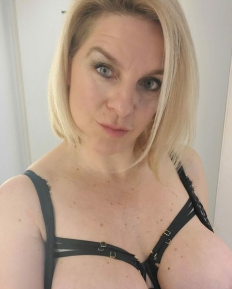 Sexy blonde mature woman flaunts her incredible cleavage and big round ass