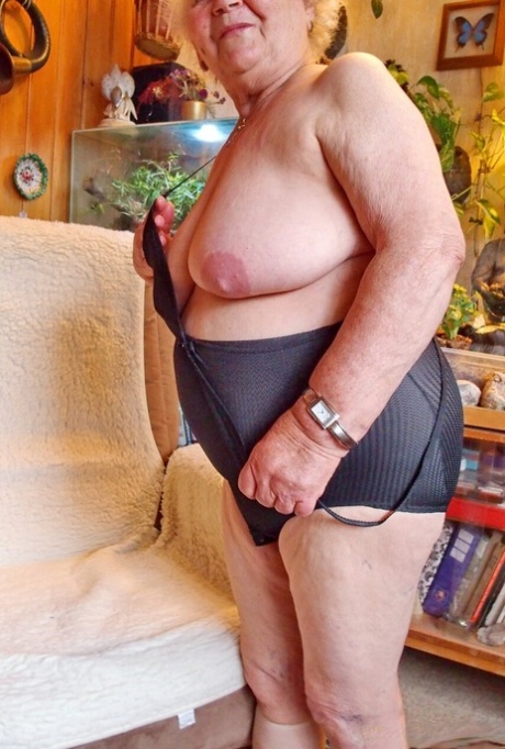Lonely granny Galfira exposes her big saggy tits while changing in a solo