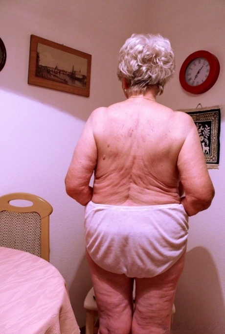 Short-haired granny Medora goes topless and shows her huge saggy tits